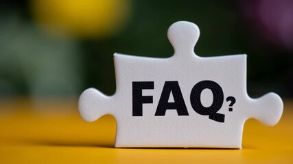 White puzzle piece labeled with the abbreviation FAQ is placed on a vibrant yellow background. This image represents the idea of addressing common inquiries and providing assistance and solutions