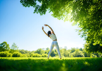 woman doing yoga exercises in the park