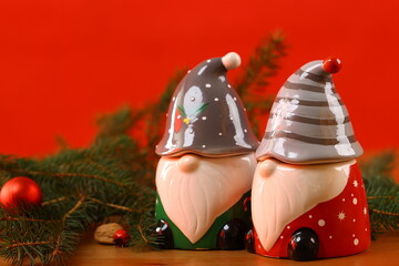 Colorful Christmas gnomes with festive spruce branches and bright holiday background