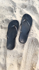 Black flip-flops on sand, Island Ko Nang Yuan Island, Surat Thani, Thailand, Southeast Asia.