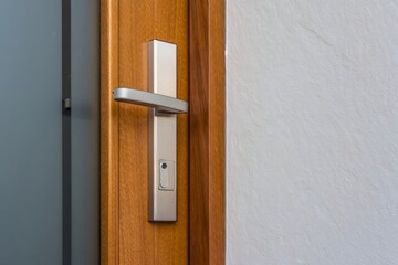 Modern Silver Door Handle on Wooden Door Close Up