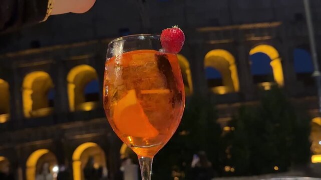 Aperol at night against the backdrop of the Colosseum in Rome. High quality 4k footage