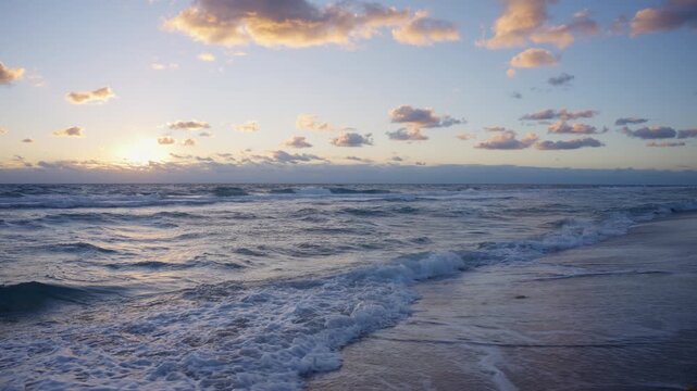 Sunrise Waves on a Tranquil Beach with Colorful Clouds