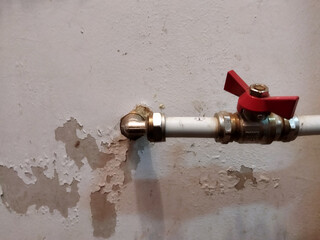 Broken pipe valve leaking water in a basement