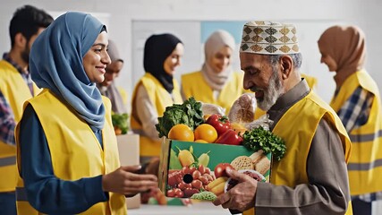 Muslim Volunteers Giving Fresh Food to Elderly Man at Charity Event.