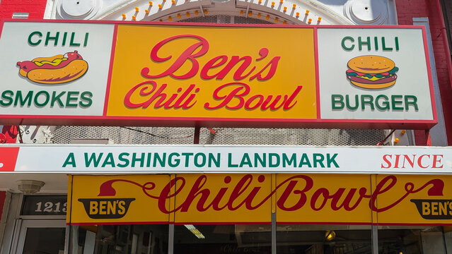 A detailed view of Ben&rsquo;s Chili Bowl&rsquo;s iconic signage promoting chili smokes and burgers, emphasizing its landmark status.