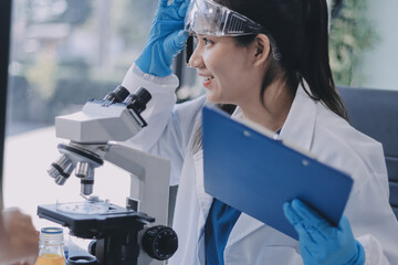 Portrait, science and happy woman on laptop in lab to research chemistry, test or innovation....