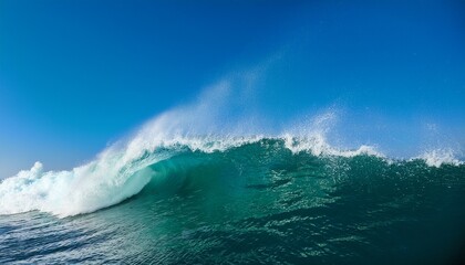 Massive Teal Ocean Wave Cresting And Spraying Water Against A Clear Blue Sky Powerful And Beautiful Force Of Nature Theme Surfing And Water Sport Concept