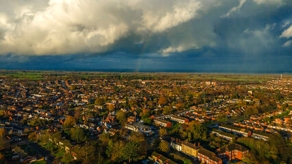 Dramatic cloudy sky over Lichfield residential suburbs and countryside
