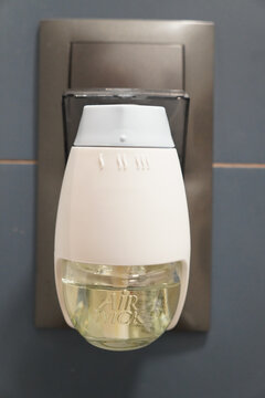 Air Wick plug-in air freshener in a modern bathroom setting