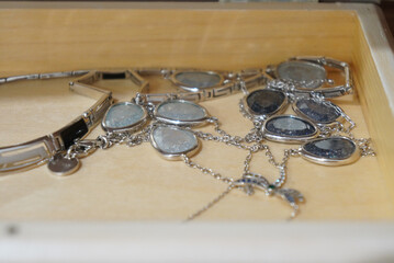 Elegant jewelry collection displayed inside a wooden drawer, close-up shot