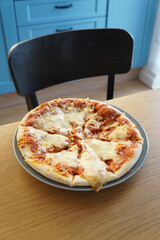 Delicious pizza with melted cheese on a plate, ready to eat