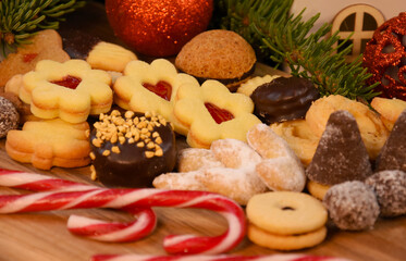 Assorted christmas cookies, sweets and christmas decorations on a wooden background stock photo images. Festive shortbread biscuits, linzer cookies and candy cane photo. Template for banner, card