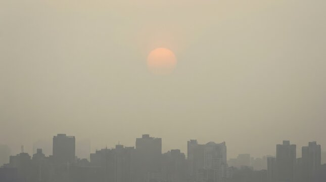 City skyline at sunset with hazy atmosphere creating a dramatic scenery over the buildings