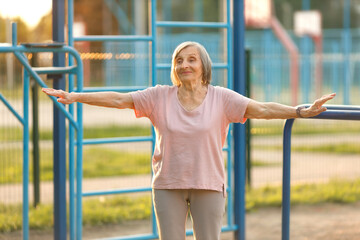 Obraz premium Happy Senior Woman Doing Fitness Outdoors. Healthy Retirement Lifestyle.