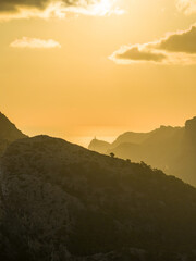 Golden sunset over the cliffs of Cap de Formentor, Mallorca, Spain. Breathtaking Mediterranean landscape with sun rays over the rocky coast &mdash; captured in stunning high resolution.