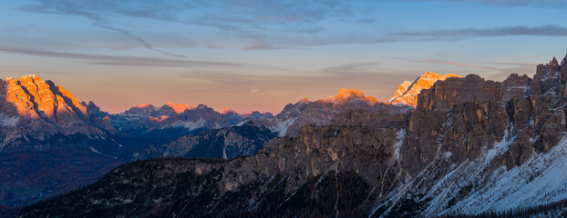 Panoramic view of Dolomite mountain peaks in beautiful morning light. Early winter scene with...