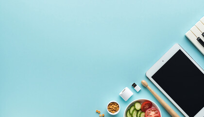 Creative workspace promoting wellness and music inspiration with tablet, keyboard, and healthy salad, perfect for lifestyle blog or digital health campaign