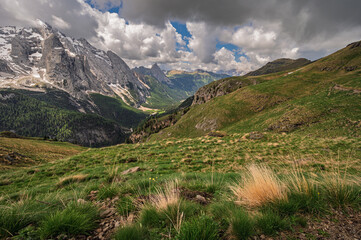 Fototapeta premium Marmolada mountain range seen from the viel del pan trail during a summer cloudy day, Canazei, Dolomites, Italy