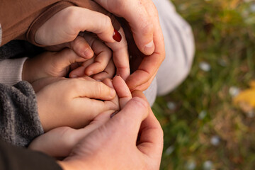 Family hands clasped together showing love and unity