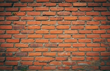 Close up photo of aged red brick wall background. Rough brickwork structure with visible texture. Construction of building facade. Decorative home exterior vintage design.