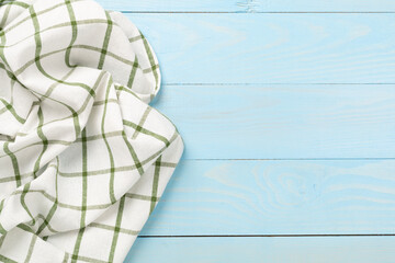 Kitchen napkin on wooden background, top view