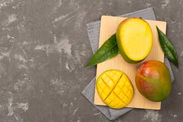 Fresh ripe mango on concrete background, top view