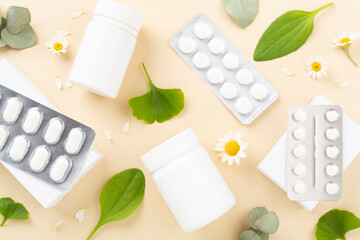 Herbs and flowers with medicines on color background, top view