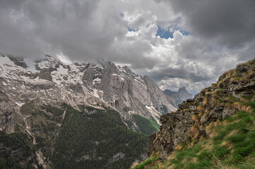 Obraz premium Marmolada mountain range seen from the viel del pan trail during a summer cloudy day, Canazei, Dolomites, Italy
