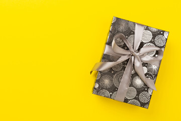 Stylish grey gift box on color background, top view