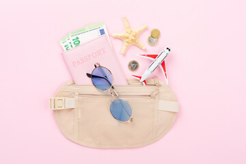 Traveler organizer bag with passport and accessories on color background, top view