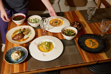 A Scrumptious Array of Gourmet Dishes Arranged Beautifully on a Wooden Dining Table