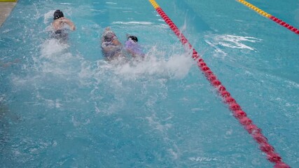 Group of children learning backstroke in a swimming pool lesson