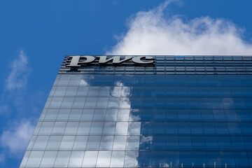 Fototapeta premium Toronto, Canada - September 21, 2025: Close up of PWC sign on the building. Toronto, Canada. PwC (PricewaterhouseCoopers) is a multinational professional services network of firms. 