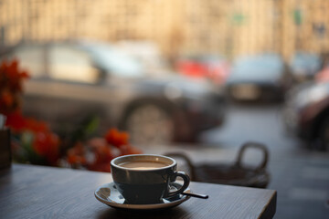A cityscape with a view from inside a cafe. View from behind the coffee table on the city landscape. High quality photo