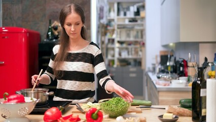 Young woman cooking in kitchen at home, healthy eating.
