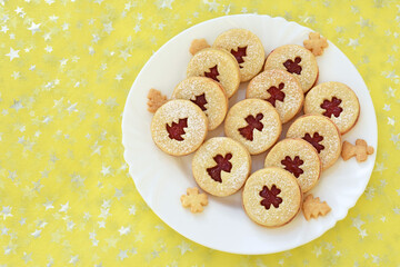 Linzer cookies on a plate, glittering background