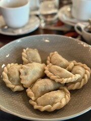 Homemade Dumplings Served on Ceramic Plate at Cafe Table