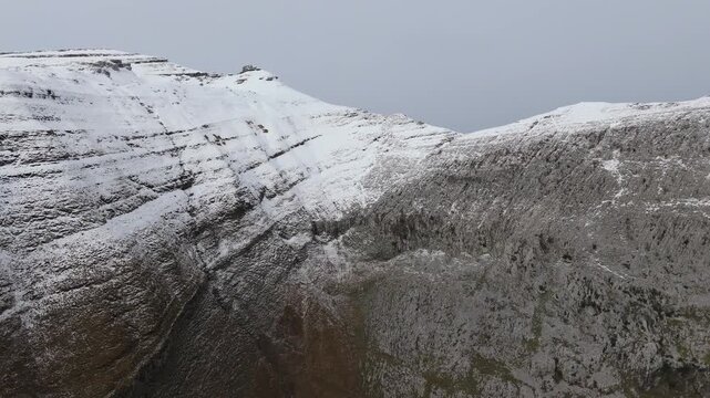 Snow-covered mountains overlook tranquil forest floor - Here is a revised description that meets the critical rules for stock photography style: Snow-covered mountains display dense forest at their.