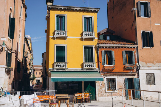 Colorful buildings lining a narrow street in Venice, Italy - Powered by Adobe