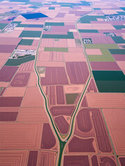 Aerial view of cultivated land with irrigation channels showcasing agricultural divisions and water distribution systems