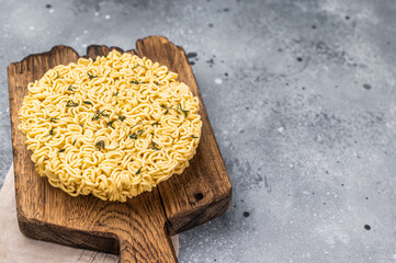 Twisted raw ramen noodles, ready to soak up flavors and bring warmth to your next culinary...
