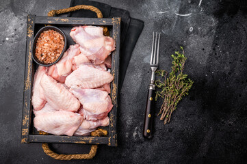 Beautifully arranged raw chicken wings, ready to soak up your favorite marinades for a tasty...