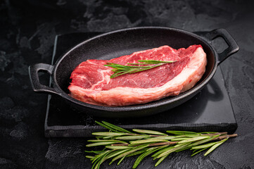 Premium raw striploin steak with rich color and texture, perfect for satisfying meat lovers at your next dinner. black background. top view