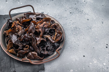 Fresh wood ear mushrooms, perfect for adding unique texture and flavor to your favorite Asian dishes. grey background. top view