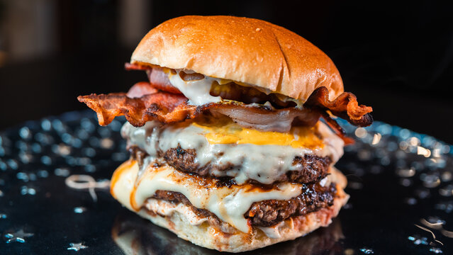 Double deck burger with crispy bacon, rare beef patties, melted cheese, and homemade mayo. Juicy, crunchy, and indulgent. Perfect for gourmet promotions.