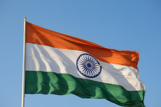 tricolor india flag with ashoka chakra blowing in clear sky