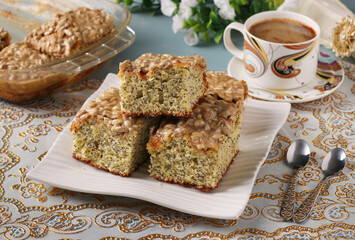 Homemade sweet cake with poppy seeds, cut into slices on white plate