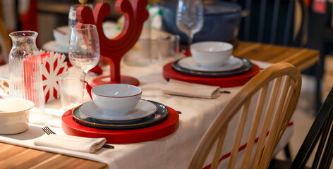 Elegant Holiday Table Setting with Red Placemats White Dishes and Festive Decorations for Christmas Dinner Celebration