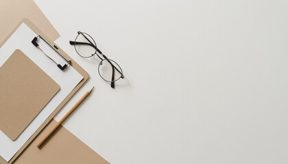 Stylish office workspace with clipboard, pencil, and glasses ready for your text or graphic, perfect for presentations or social media posts